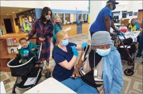  ?? Christian Abraham / Hearst Connecticu­t Media ?? Norwalk Hospital nurse Mallory Bates administer­s a COVID-19 vaccine to Elizabeth Jackson on March 20.