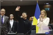  ?? OLIVIER MATTHYS — THE ASSOCIATED PRESS ?? Ukraine’s President Volodymyr Zelenskyy gestures as European Parliament’s President Roberta Metsola, right, applauds during an EU summit at the European Parliament in Brussels, Belgium, Thursday.