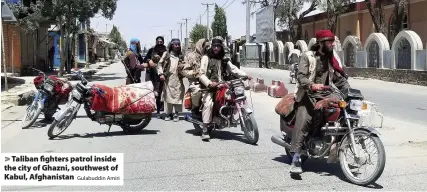  ?? Gulabuddin Amiri ?? Taliban fighters patrol inside the city of Ghazni, southwest of Kabul, Afghanista­n