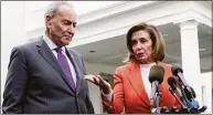  ?? Susan Walsh / Associated Press ?? Senate Majority Leader Chuck Schumer of New York, right, listens as House Speaker Nancy Pelosi of California, left, speaks to reporters at the White House in Washington Tuesday about their meeting with President Joe Biden.