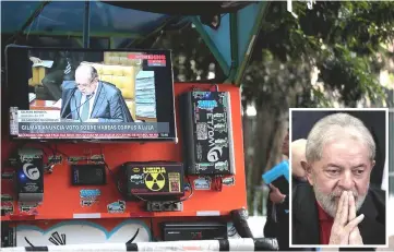  ??  ?? A TV monitor shows a televised session of the Brazilian Supreme Court issuing its final decision about a habeas corpus plea for Lula (inset) in Sao Paulo, Brazil. — Reuters photo