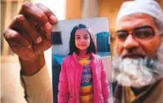  ?? AP ?? Mohammad Amin shows a picture of his 8-year-old daughter, Zainab Ansari, in Kasur. The death verdict has been upheld for the man convicted of murdering the girl.