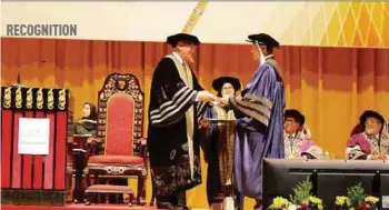  ??  ?? Tan Sri Lee Lam Thye (right) receiving his scroll from Asia Metropolit­an University Chancellor General (Rtd) Tan Sri Mohd Zahidi Zainuddin at the university's 11th Convocatio­n in Serdang.