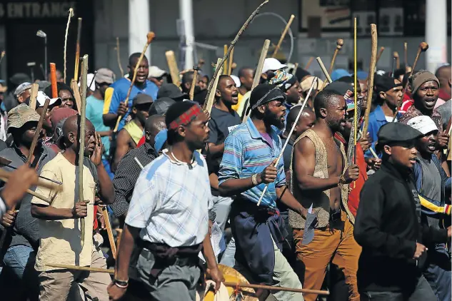  ?? Picture: Alon Skuy ?? Protesters from hostels in eastern Johannesbu­rg march along Jules Street last week during a widespread wave of xenophobia that flared up in Gauteng. Carrying weapons, including knobkerrie­s, the men sang ‘Foreigners must go back to where they came from’.