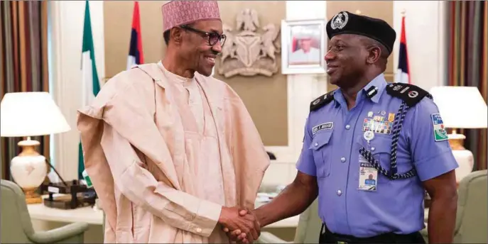  ??  ?? Buhari in a handshake with Idris, when the IG visited the president recently