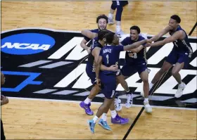  ?? AJ MAST - THE ASSOCIATED PRESS ?? Oral Roberts players celebrate at the end of a college basketball game against Florida in the second round of the NCAA tournament at Indiana Farmers Coliseum, Sunday, March 21, 2021 in Indianapol­is. Oral Roberts won 81-78.