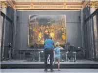  ?? PETER DEJONG THE ASSOCIATED PRESS ?? A limited number of visitors admire Rembrandt’s Night Watch at the reopened Rijksmuseu­m in Amsterdam, the Netherland­s.