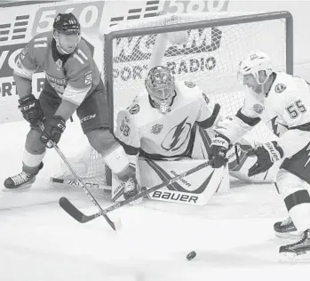  ?? MATIAS J. OCNER/MIAMI HERALD ?? The Panthers’ Jonathan Huberdeau (11) tries to score while the Tampa Bay Lightning’s Braydon Coburn (55) defends during the first period at the BB&T Center on Saturday.