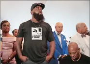  ?? JEFF ROBERSON/AP PHOTO ?? Michael Brown Sr. stands as an honor guard enters during the dedication Wednesday of a new community empowermen­t center in Ferguson, Mo. center was built on the property where a QuikTrip convenienc­e store was burned during rioting after a white officer...