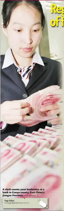  ?? File photo: IC ?? A clerk counts yuan banknotes at a bank in Ganyu county, East China’s Jiangsu Province.