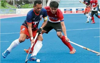  ??  ?? Steadfast: Marhan’s (left) cool play on the pitch makes him the first choice in national coach Roelant oltmans’ line-up.