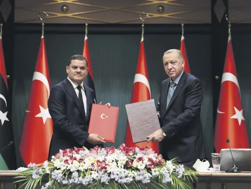  ??  ?? Libya’s Prime Minister Abdul Hamid Mohammed Dbeibah (L) and President Recep Tayyip Erdoğan pose for a photo during a signing ceremony after their meeting in the capital Ankara, Turkey, April 12, 2021.