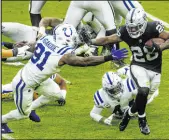  ?? L.E. Baskow Las Vegas Review-journal @Left_eye_images ?? Colts defensive end Yannick Ngakoue, trying to tackle Raiders running back Josh Jacobs on Nov. 13, played for the Raiders in 2021 before being traded away by the team’s new leadership.