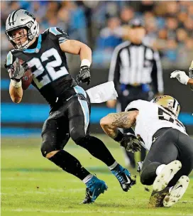  ?? [AP PHOTO] ?? Carolina Panthers’ Christian McCaffrey (22) evades a tackle by New Orleans Saints’ A.J. Klein during the first half Monday night in Charlotte, N.C.