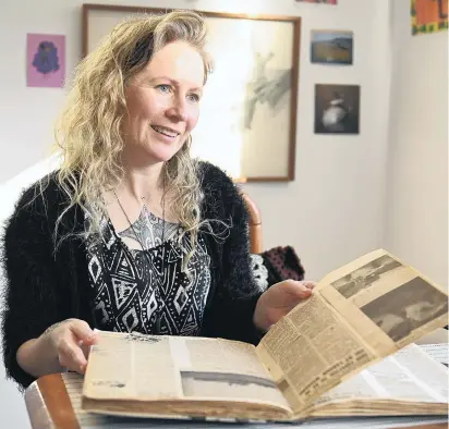  ?? PHOTOS: LINDA ROBERTSON ?? Author Becky Manawatu flicks through her nana’s scrapbook.