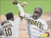  ?? Sean M. Haffey / Getty Images ?? Fernando Tatis Jr., right, is greeted by Jurickson Profar after a postseason home run. Tatis said for San Diego, “This is just getting started.”