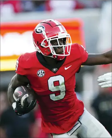  ?? JOHN BAZEMORE — THE ASSOCIATED PRESS ?? Georgia wide receiver Jackson Meeks (9) tries to fight off an Auburn defender during the second half of the Bulldogs’ win Saturday.