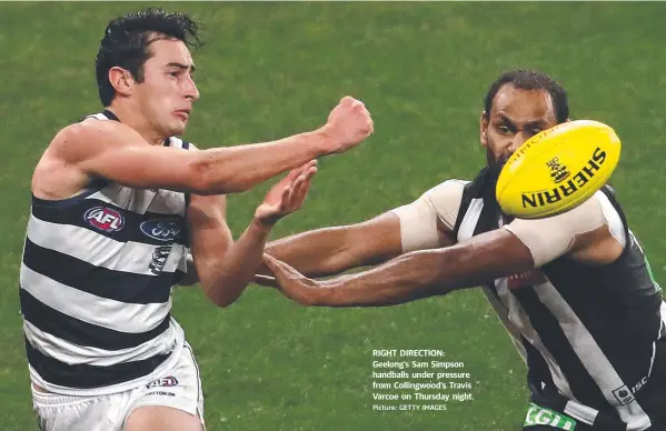  ?? Picture: GETTY IMAGES ?? RIGHT DIRECTION: Geelong’s Sam Simpson handballs under pressure from Collingwoo­d’s Travis Varcoe on Thursday night.