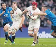  ?? AFP ?? England flanker James Haskell is tackled by Italy flanker Simone Favaro.