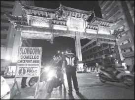  ?? MIGUEL DE GUZMAN ?? Members of the Manila Police District flag down motorists passing in Binondo, Manila yesterday as they implement a stricter Comelec checkpoint with the start of the campaign period for the midterm polls in May.