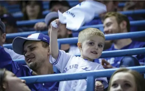  ?? DAVID COOPER/TORONTO STAR ?? Ashton Mercer, 3, got a special birthday present, going with his dad Justin to the Blue Jays’ home opener against Tampa Bay on Monday night.