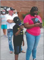  ??  ?? Voters wearing masks wait in line to vote early outside the Chatham County Board of Elections office. (AP/Russ Bynum)