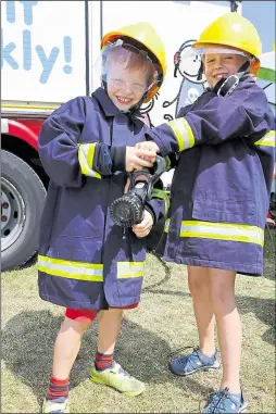  ?? 2929615 ?? Rory and Erin Collins, aged five and eight, from Canterbury try out the fire suits