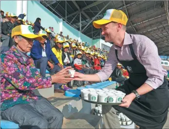  ?? PROVIDED TO CHINA DAILY ?? A barista from Starbucks serves brewed coffee to farmers in Yunnan province.