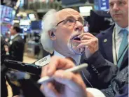  ?? RICHARD DREW/AP ?? Trader Peter Tuchman works on the floor of the New York Stock Exchange on Tuesday. The Dow slid 505 points at its low.