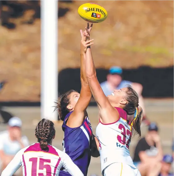  ?? Picture: AAP IMAGE ?? Parris Laurie (left) of the Dockers and Lauren Bella of the Lions jump for the ball during yesterday’s AFLW match.
