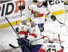  ?? MICHAEL DWYER / AP ?? Florida Panthers’ Aleksander Barkov celebrates after his goal with Kyle Okposo, Gustav Forsling and Vladimir Tarasenko on Sunday against the Bruins. Florida went on to win 3-2.