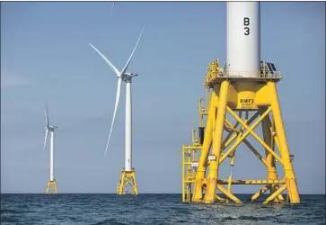  ?? Michael Dwyer Associated Press ?? THE BIDEN administra­tion’s plan to address global warming includes harnessing offshore wind and boosting onshore renewable energy production. Above, turbines near Rhode Island, the first U.S. offshore wind farm.