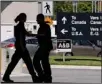 ?? Canadian Press file photo ?? Canadian border guards are silhouette­d as they replace each other at an inspection booth at the Douglas crossing on the CanadaU.S. border in Surrey. Fewer Canadians are being turned away at the U.S. land border, The Canadian Press has learned.