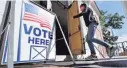  ?? CHARLES KRUPA, AP ?? A resident arrives to cast her vote at a polling station at the Kennebunk Town Hall in Kennebunk, Maine, on June 12.