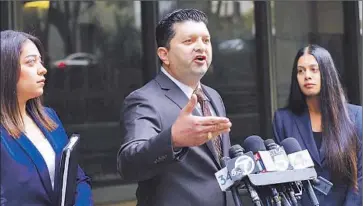  ?? Lawrence K. Ho
Los Angeles Times ?? DEFENSE ATTORNEY Eber Bayona, center, said that Lyvette Crespo was a battered and abused woman and that she would claim self-defense in shooting Daniel Crespo during an argument in 2014.