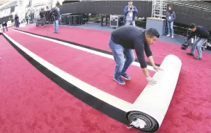  ?? Picture: EPA ?? READY TO ROLL. A worker rolls out the red carpet during preparatio­ns for the 89th Academy Awards in Hollywood, Los Angeles.