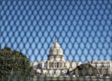  ?? Photog r aphs by Kent Nishimura Los Angeles Times ?? INVOKING the 25th Amendment or pursuing a second impeachmen­t would take time in the waning days of President Trump’s term in off ice. Above, security measures are heightened on Thursday near the U. S. Capitol.