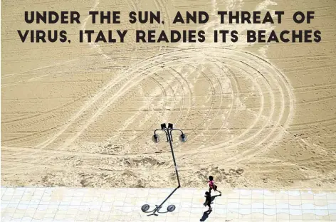  ?? – AFP photos ?? A woman jogs by a beach along the seafront in Jesolo, near Venice, northeaste­rn Italy, during the country’s lockdown.