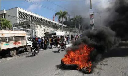  ?? ?? A burning tyre as protesters call for the resignatio­n of Ariel Henry. Photograph: Ralph Tedy Erol/Reuters