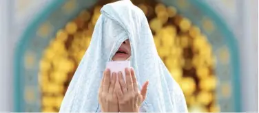  ?? Associated Press ?? ↑
A worshipper offers Eid Al Fitr prayer outside a shrine in Tehran, Iran, on Sunday.