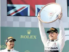  ??  ?? VALTERRI Bottas (R) of Finland holds the winners trophy alongside second place Britain’s Lewis Hamilton (L) after the Formula 1 2019 Australian Grand Prix at the Albert Park Grand Prix Circuit in Melbourne, Australia yesterday. | EPA-EFE