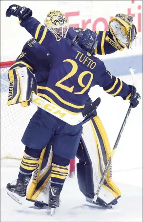  ?? Arnold Gold / Hearst Connecticu­t Media ?? Quinnipiac’s Odeen Tufto, right, celebrates with goalie Andrew Shortridge after defeating Yale at Ingalls Rink in New Haven in 2019.