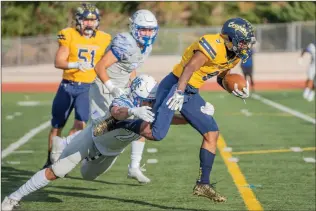  ?? Bobby Block/The Signal ?? College of the Canyons’ Trevon Elliott (9) fends off an attempt to tackle him by a Hancock player during Saturday’s game.