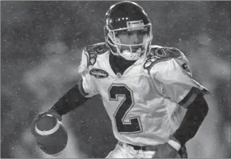  ?? The Canadian Press ?? Toronto Argonauts quarterbac­k Doug Flutie scrambles with the ball during first half action against the Edmonton Eskimos at the Grey Cup in Hamilton, Ont. in 1996.