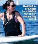  ??  ?? MAKING A SPLASH: Anna takes a rest on her windsurfin­g board