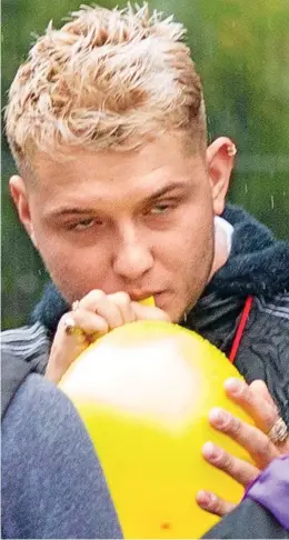  ??  ?? Air we go: Rafferty is seen pressing his lips to yellow balloon