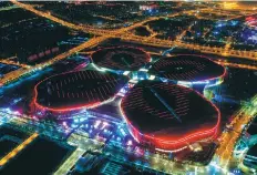  ?? DING TING / XINHUA ?? The National Exhibition and Convention Centre in Shanghai lights up the night sky. The sixday China Internatio­nal Import Expo opened at the centre on Nov 5.