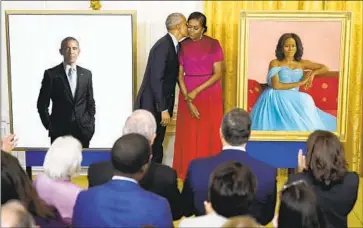  ?? FORMER FIRST LADY Andrew Harnik Associated Press ?? Michelle Obama, with former President Obama, said at Wednesday’s belated unveiling that their official White House portraits are “a reminder that there’s a place for everyone in this country.”