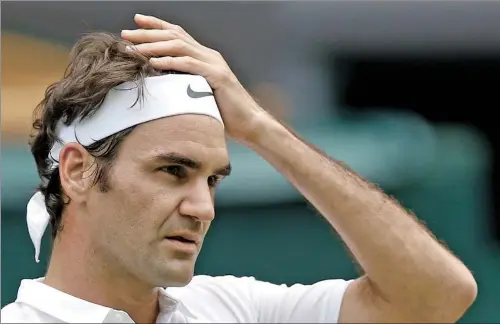  ?? KIRSTY WIGGLESWOR­TH / AP FILE ?? Roger Federer reacts during his fourth-round victory over Steve Johnson at Wimbledon in July. Federer says he has been advised by doctors to remain sidelined for the remainder of 2016.