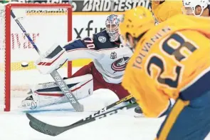  ?? MARK HUMPHREY/AP ?? Eeli Tolvanen gives the Predators the lead for good Sunday by slipping a power-play goal past Blue Jackets goaltender Joonas Korpisalo in the second period, sending Columbus to its fifth straight defeat.